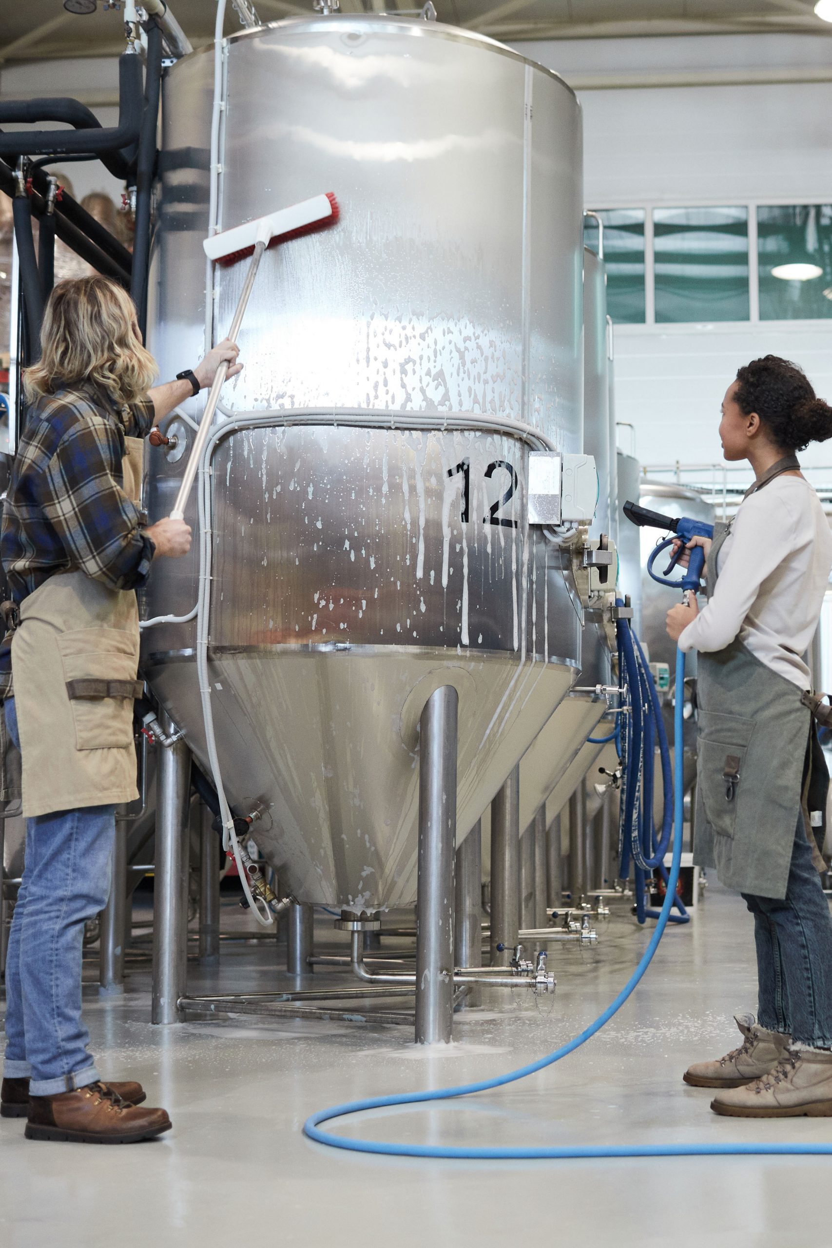 young-people-cleaning-workshop-at-factory-